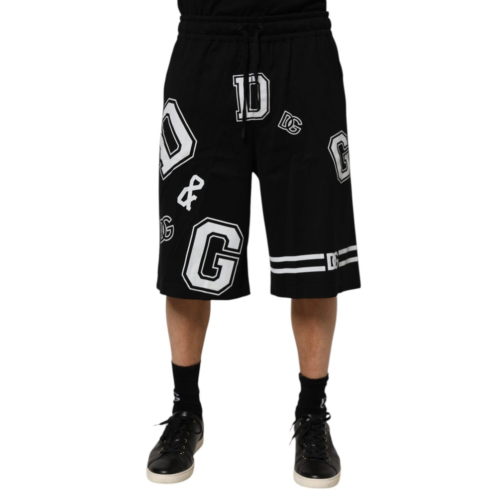 Model wearing Dolce & Gabbana Black Logo Print Cotton Casual Bermuda Short with stylish logo print and drawstring closure.