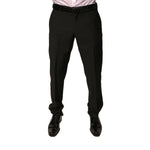 Man wearing Dolce & Gabbana Black Wool Tapered Formal Dress Pants with button and zipper closure, mid waist design, made in Italy.