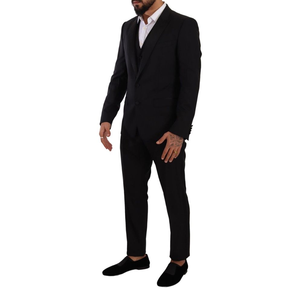 Man wearing a Dolce & Gabbana Black Wool Three-Piece Suit with deconstructed blazer, slim fit trousers, and a vest, shown in profile.