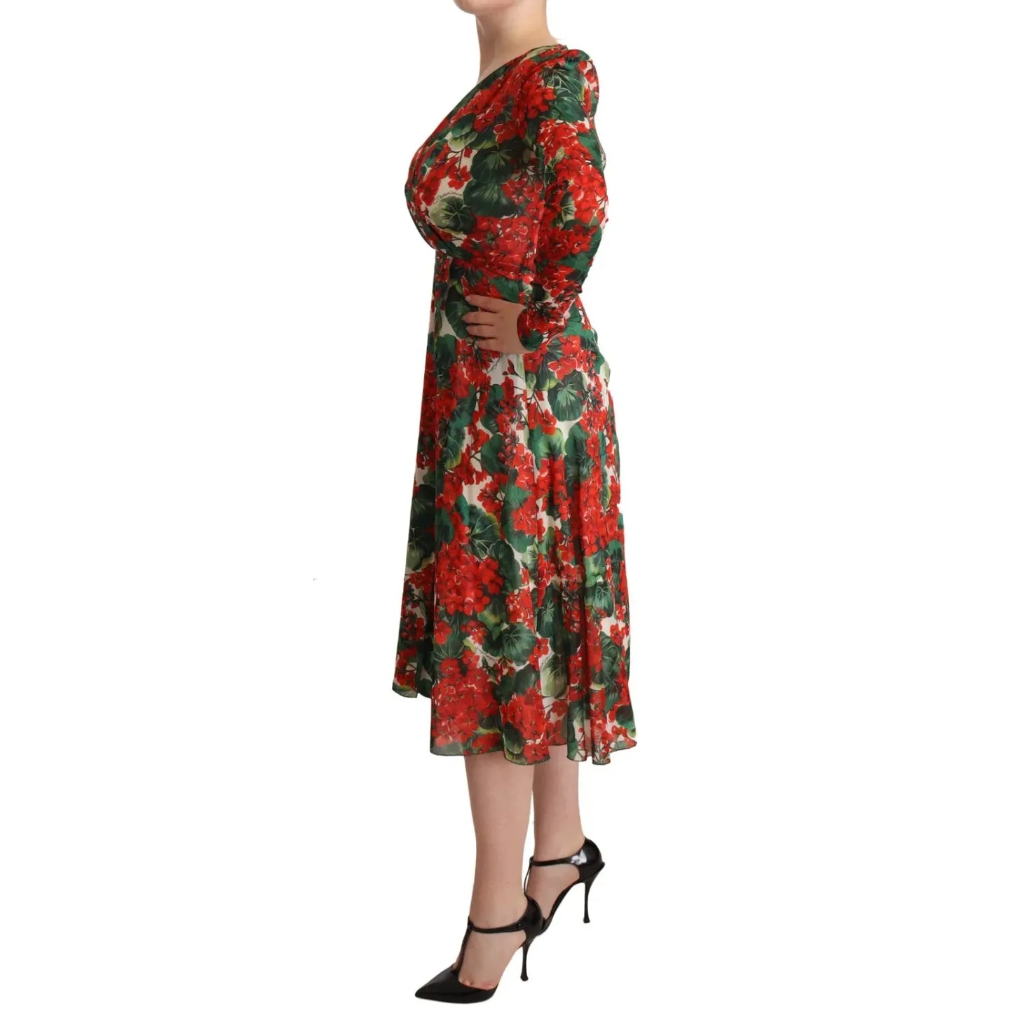 Woman wearing Dolce & Gabbana Multicolor Portofino-Print Shift Dress with red and green floral pattern, side view, long sleeves, V-neck.