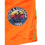 Dolce & Gabbana Orange Polyester Beachwear Men Shorts Swimwear featuring logo detail.