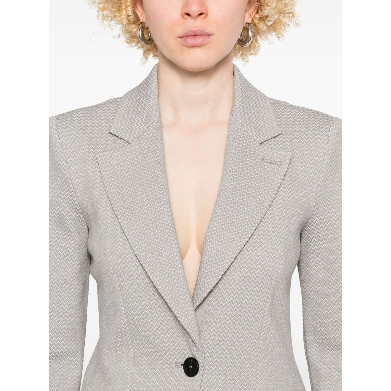 Emporio Armani Icon Blazer in light grey with button fastening, two side pockets, and shoulder pads, modeled by person wearing size 40 IT.