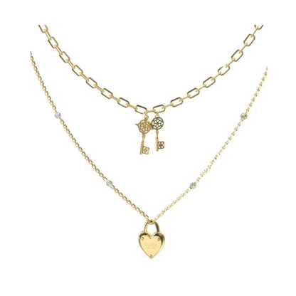 GUESS JEWELS JEWELRY Mod. JUBN04216JWYGT-U gold layered necklace with heart and key charms.