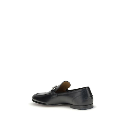 Gucci Black Calf Leather Bos Taurus Slip-On Loafers with metallic Morsetto detail and embossed logo, side view.