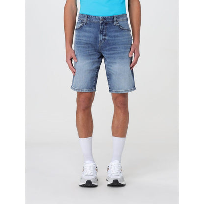 Man wearing Hugo Boss Blue Denim Shorts, size 40, featuring durable denim material and practical pockets, perfect for versatile styling.