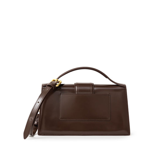 Jacquemus Brown Leather Le Grand Bambino Handbag with gold hardware, adjustable strap, card pocket, and magnetic flap closure.