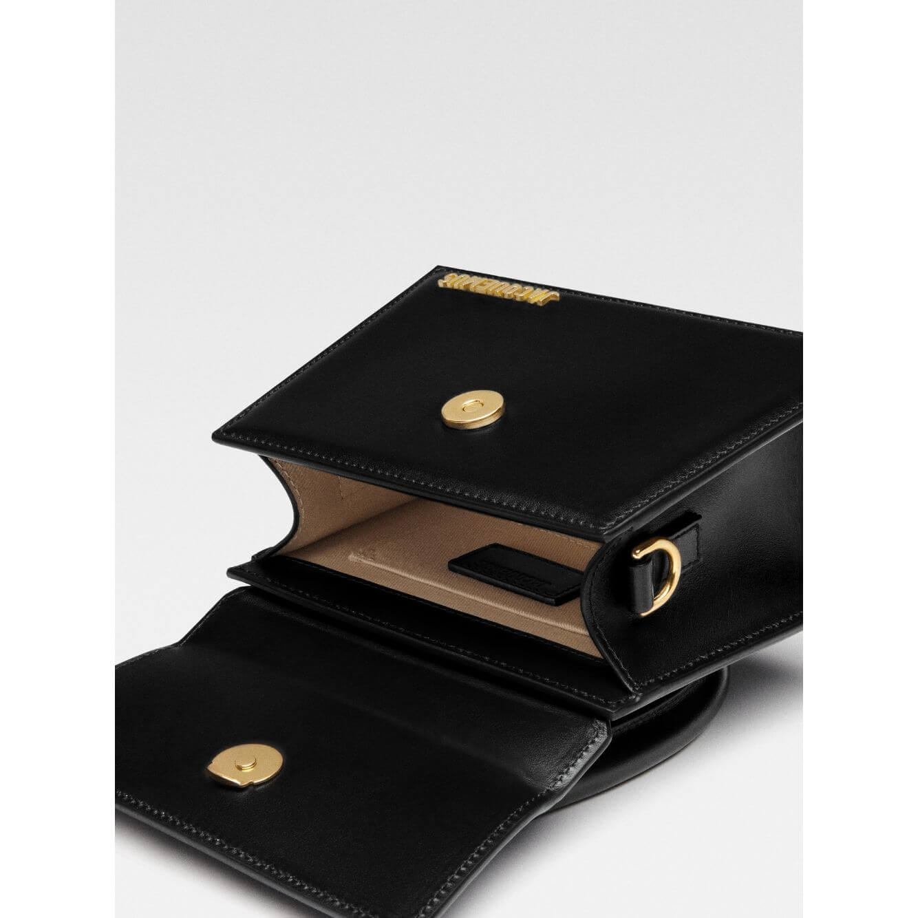 Jacquemus Le Chiquito Moyen Black Bag open showing interior and logo with gold hardware and magnetic flap closure.