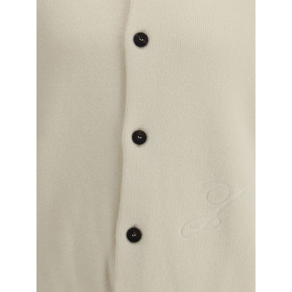 Close-up of Jacquemus White Fleece Wool Cardigan featuring black buttons and embroidered detail on the right.