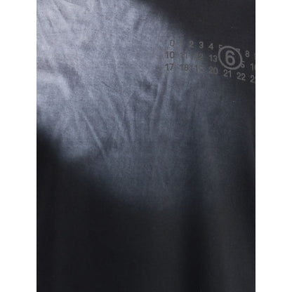 Close-up of MM6 Black Cotton T-Shirt featuring ribbed crew neck and front logo detailing, showcasing the brand's minimal design aesthetic.