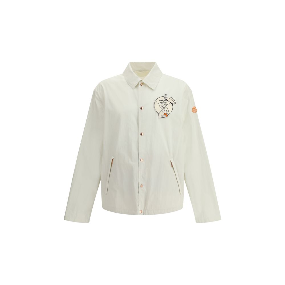 Moncler x Donald Glover White Cotton Coat with comic-style patches, part of the Moncler Genius line, featuring embroidered Moncler mascot.