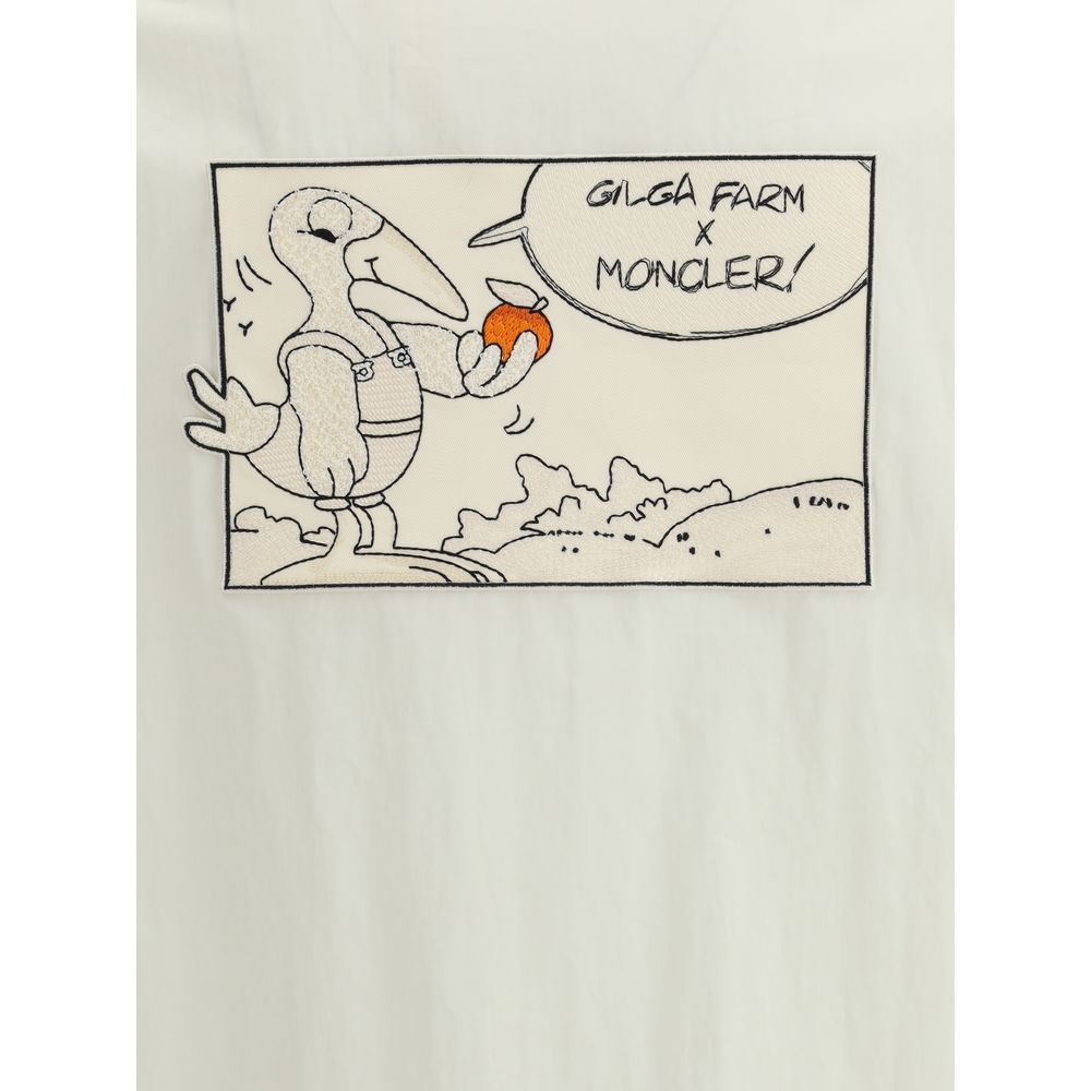 Moncler x Donald Glover White Cotton Coat featuring comic-style patch with Moncler mascot visiting Gilga Farm, artistic and functional design.