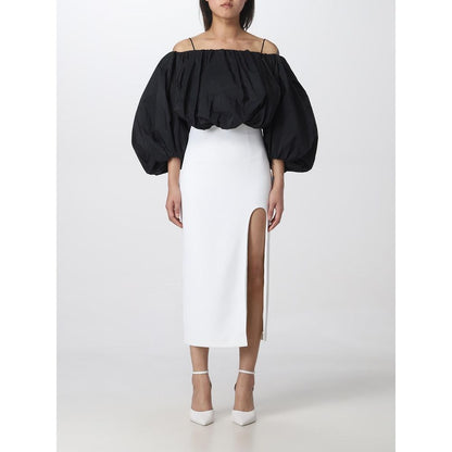 Model wearing PINKO White Polyester Midi Skirt with thigh slit, showcasing elegant design, size 42.