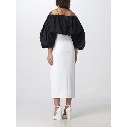 Back view of PINKO White Polyester Midi Skirt with thigh slit, size 42, styled with black off-shoulder top and white heels.