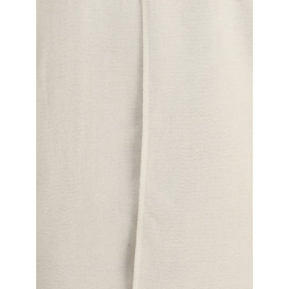 Close-up of Rick Owens Cream Camel Hair Coat showing the off-white asymmetrical front overlay and straight hem, AW25 season.