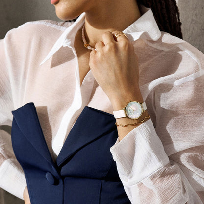 Woman wearing SKAGEN Mod. ANITA LILLE wristwatch with gold SS IP case and white leather strap, mother of pearl dial, official box packaging.