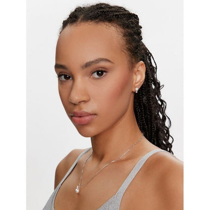 Woman wearing SWAROVSKI Mod. 5689624 silver earrings and necklace, highlighting elegant jewelry for ladies with official packaging.