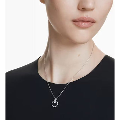 Woman wearing elegant silver necklace with circular pendant