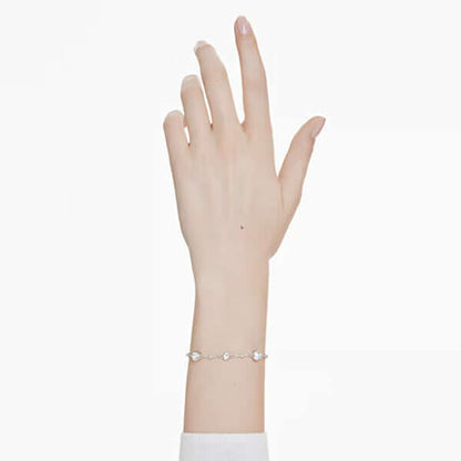 Elegant wrist wearing SWAROVSKI Mod. 5696079 Imber Bracelet, rhodium plated with white round cut stones, showcasing a subtle shimmer.