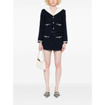 Self-portrait Jackets Blue - navy blue bouclé short jacket with stripe trim, contrasting collar, and welt pockets, modeled with white handbag.