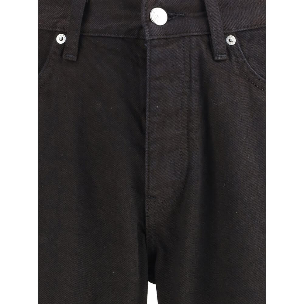 Close-up of Sunflower Black Cotton Relaxed Fit Jeans with button closure and belt loops, showcasing sustainable fashion design.