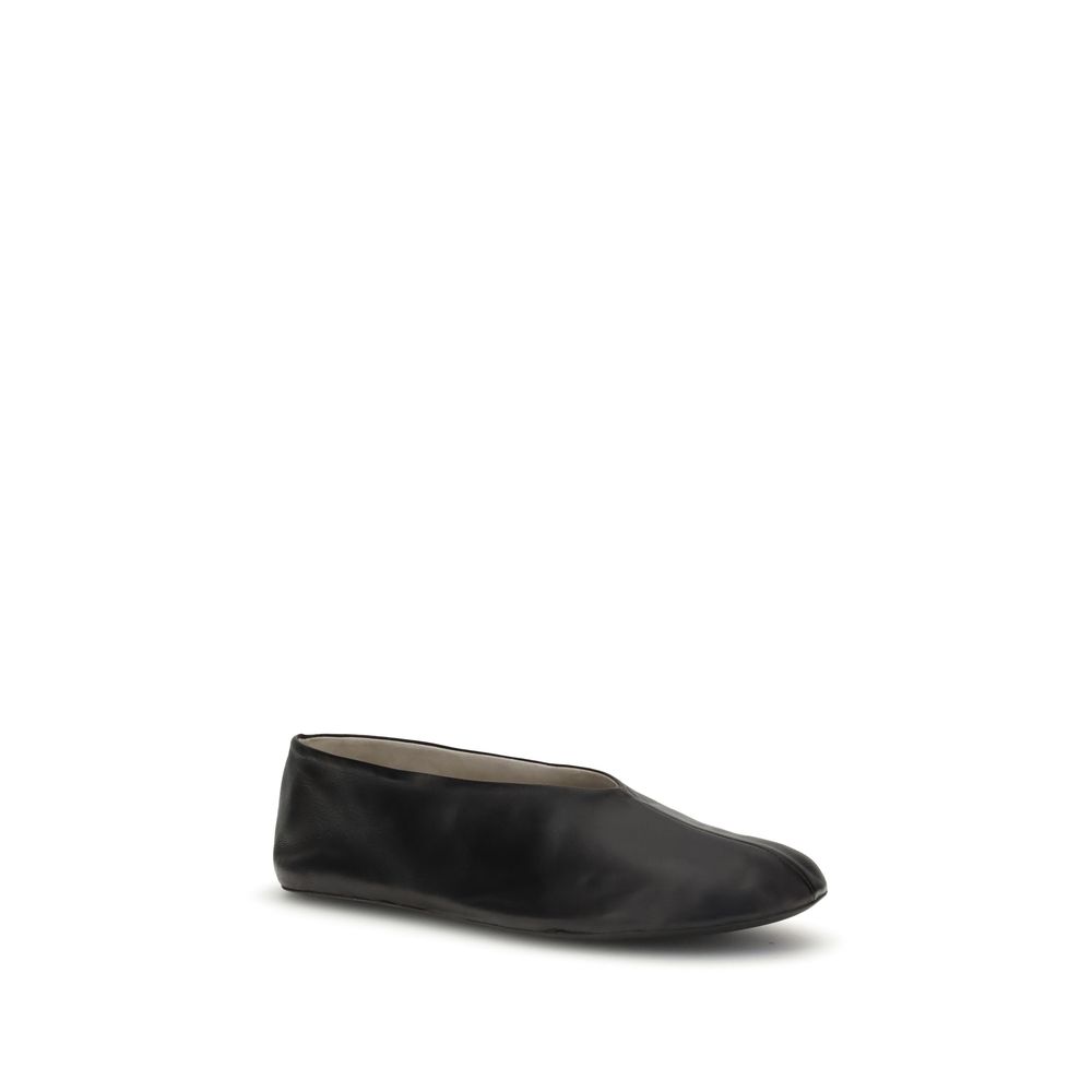 The Row Black Lamb Ovis Aries Aries Ballet Flats in fine grained nappa leather with sleek silhouette and tapered toe.