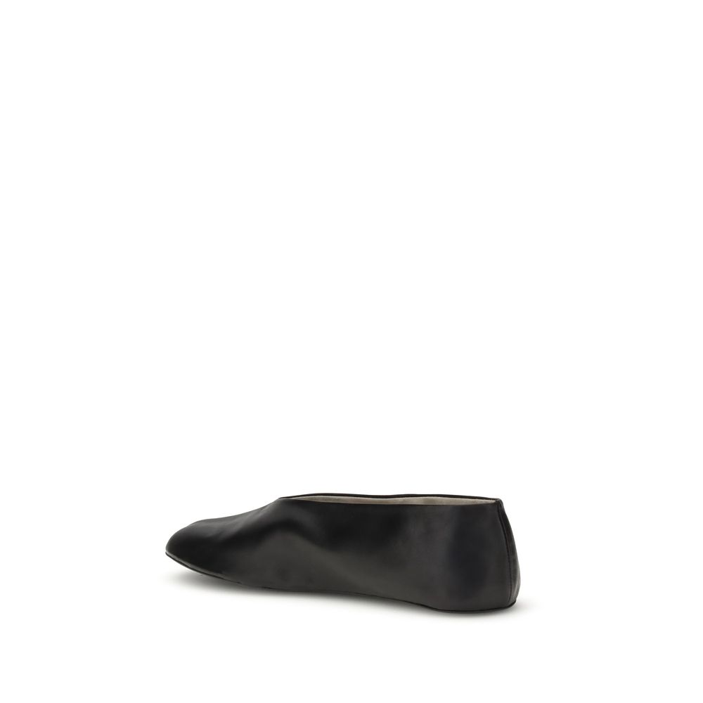 Side view of The Row Black Lamb Ovis Aries Aries Ballet Flats with sleek silhouette, made from fine nappa leather.