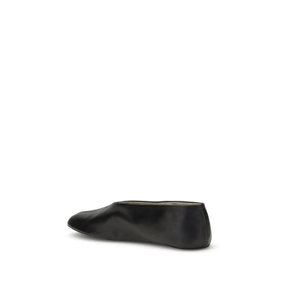 Side view of The Row Black Lamb Ovis Aries Aries Ballet Flats with sleek silhouette, made from fine nappa leather.