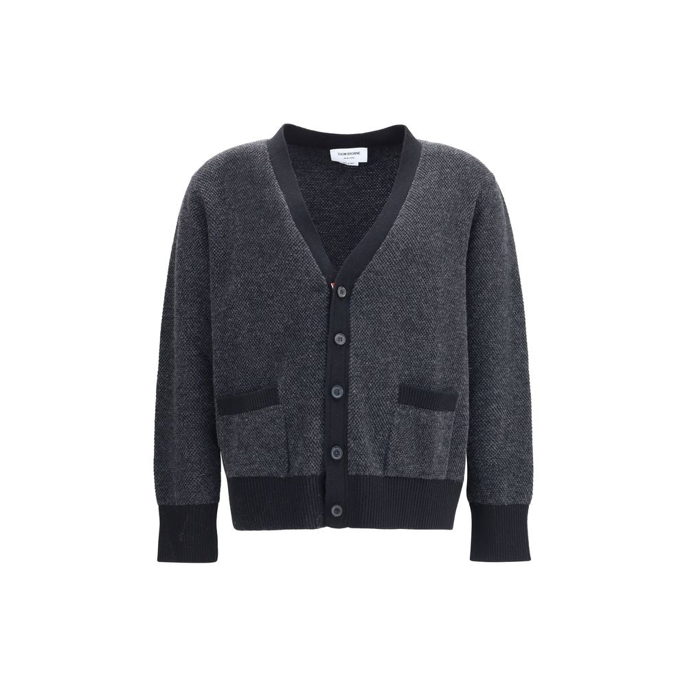 Thom Browne Black Fleece Wool Cardigan featuring V-neck and front button closure with patch pockets, ribbed cuffs, and hem.