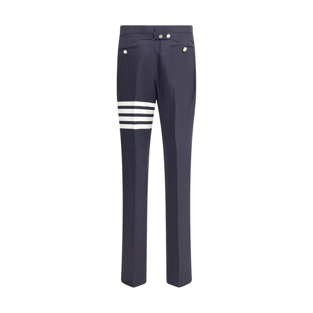 Thom Browne Blue Wool Dress Pants with iconic bands and contrasting buttons, featuring side pockets and back welt pockets for formal elegance.