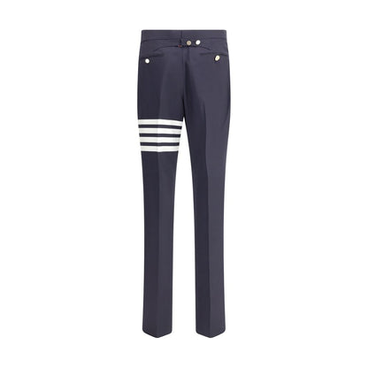 Thom Browne Blue Wool Dress Pants with iconic bands and contrasting buttons, featuring side pockets and back welt pockets for formal elegance.