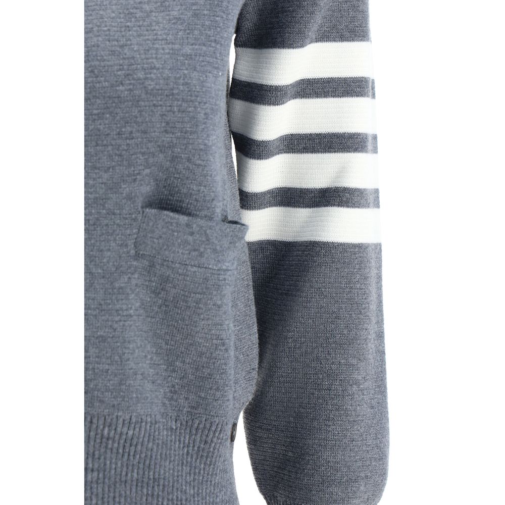 Close-up of Thom Browne Cardigan featuring striped black and white cuffs, fleece wool fabric, part of the iconic design.