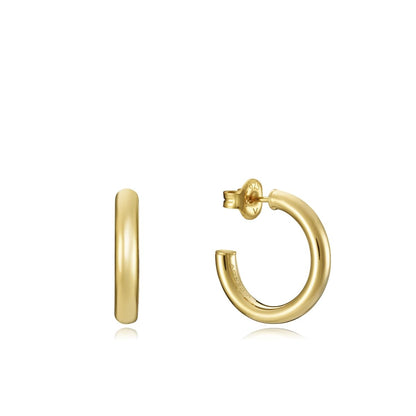 Gold hoop earrings with post closure on white background.