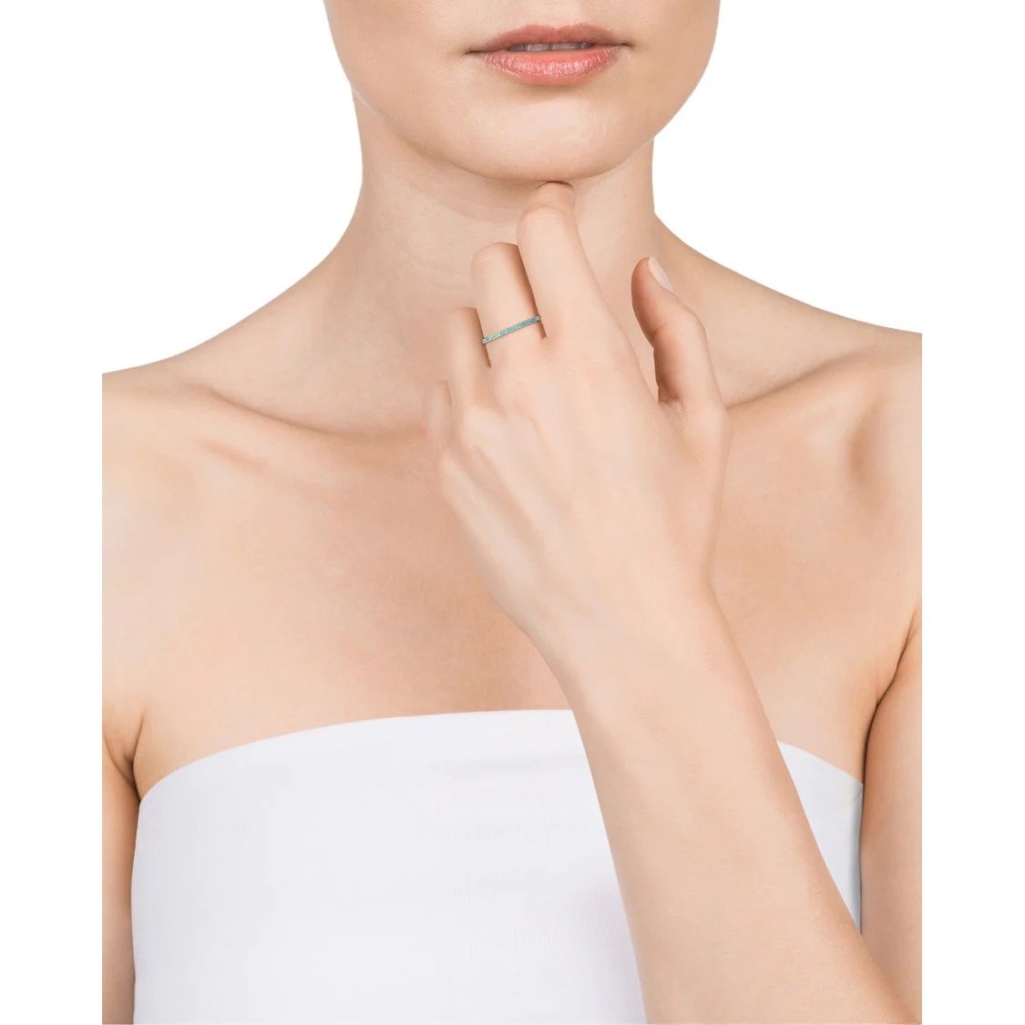Woman wearing a stylish ring on her finger, showcasing elegant minimalist jewelry design.