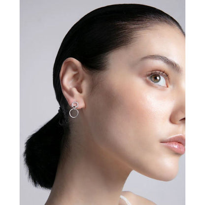 Lady wearing VICEROY JEWELS Mod. 13214E000-30 silver earrings with quartz analog design, 10 ATM water resistant, in official packaging.