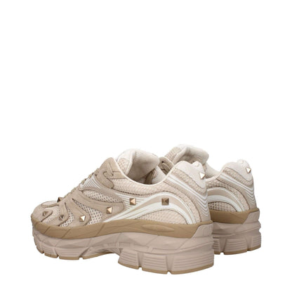 Valentino Garavani Beige Fabric Low Top Sneakers with studs, lace-up closure, rubber sole, and round toe, shown from the back angle.