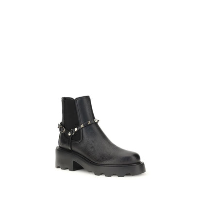Valentino Garavani Black Calf Leather Bos Taurus Ankle Boots with studs and elastic inserts, side view on white background.