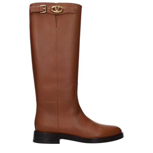 Valentino Garavani Brown Leather Boots with side logo and buckle closure, featuring a low flat heel and round toe design.