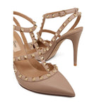 Valentino Garavani Rockstud Décolleté With 100mm Straps in powder pink leather featuring gold-tone Rockstud details and stiletto heel.