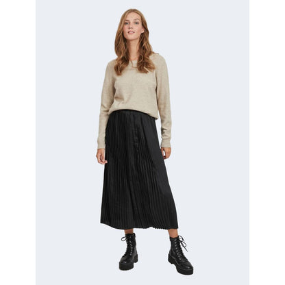 Model wearing Vila Clothes Beige Viscose Sweatshirt with pleated black skirt and boots.
