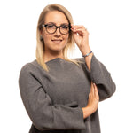 Woman wearing Zadig & Voltaire Black Women Glasses Frame with oval full-rim design in black.