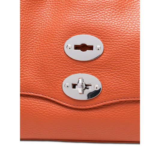 Close-up of orange twist-lock fastening on Zanellato Postina Daily Small leather handbag with stud detailing.